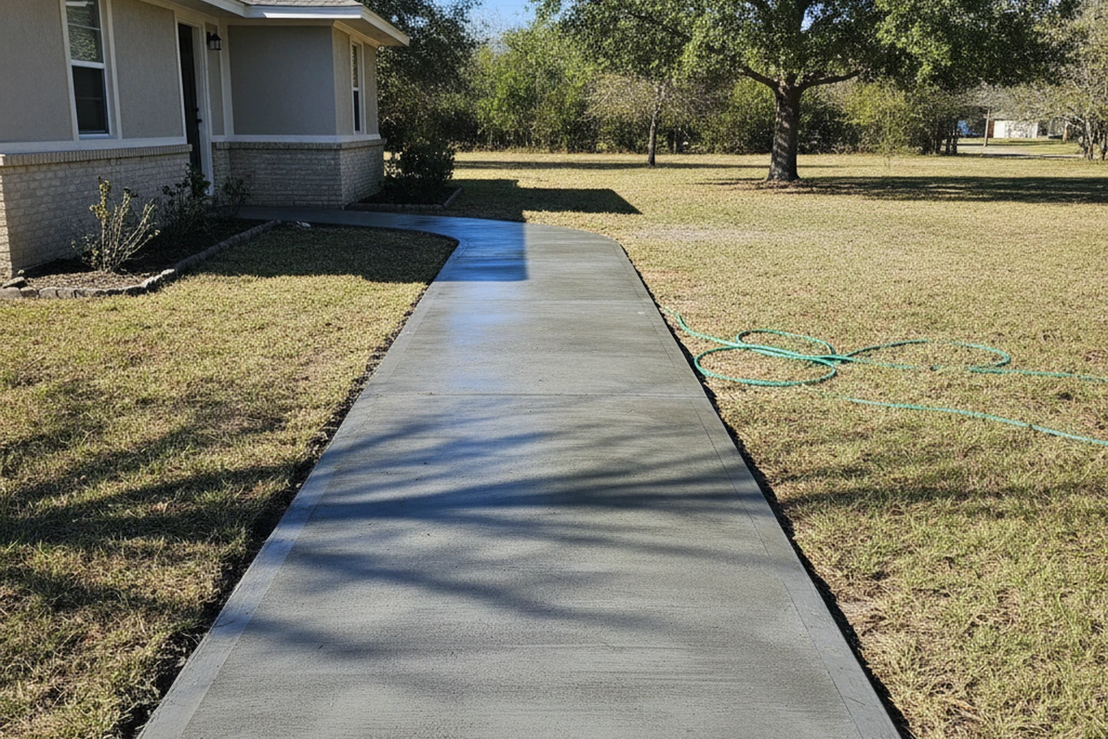 Concrete walkway installation Gautier Mississippi Jackson County Gulf Coast residential broom finish slip resistant drainage